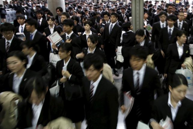 Job seekers walk into a job fair held for fresh graduates in Tokyo, Japan, March 20, 2016. REUTERS/Yuya Shino