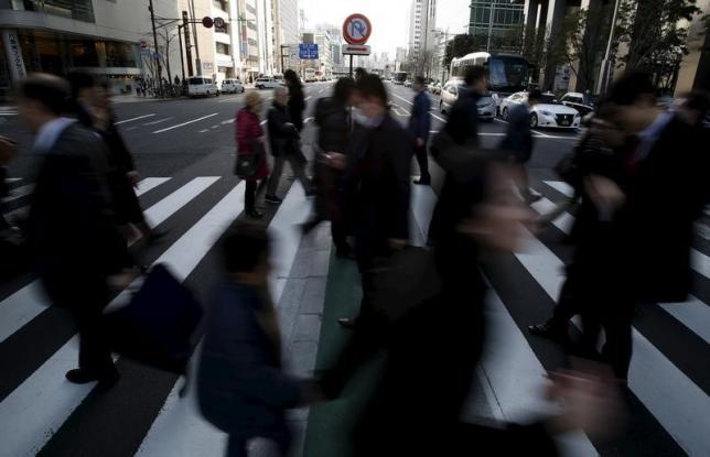 Pedestrians walk past a "no U-turn" traffic sign as they cross a street at a business district in Tokyo, Japan, February 19, 2016. REUTERS/Yuya Shino